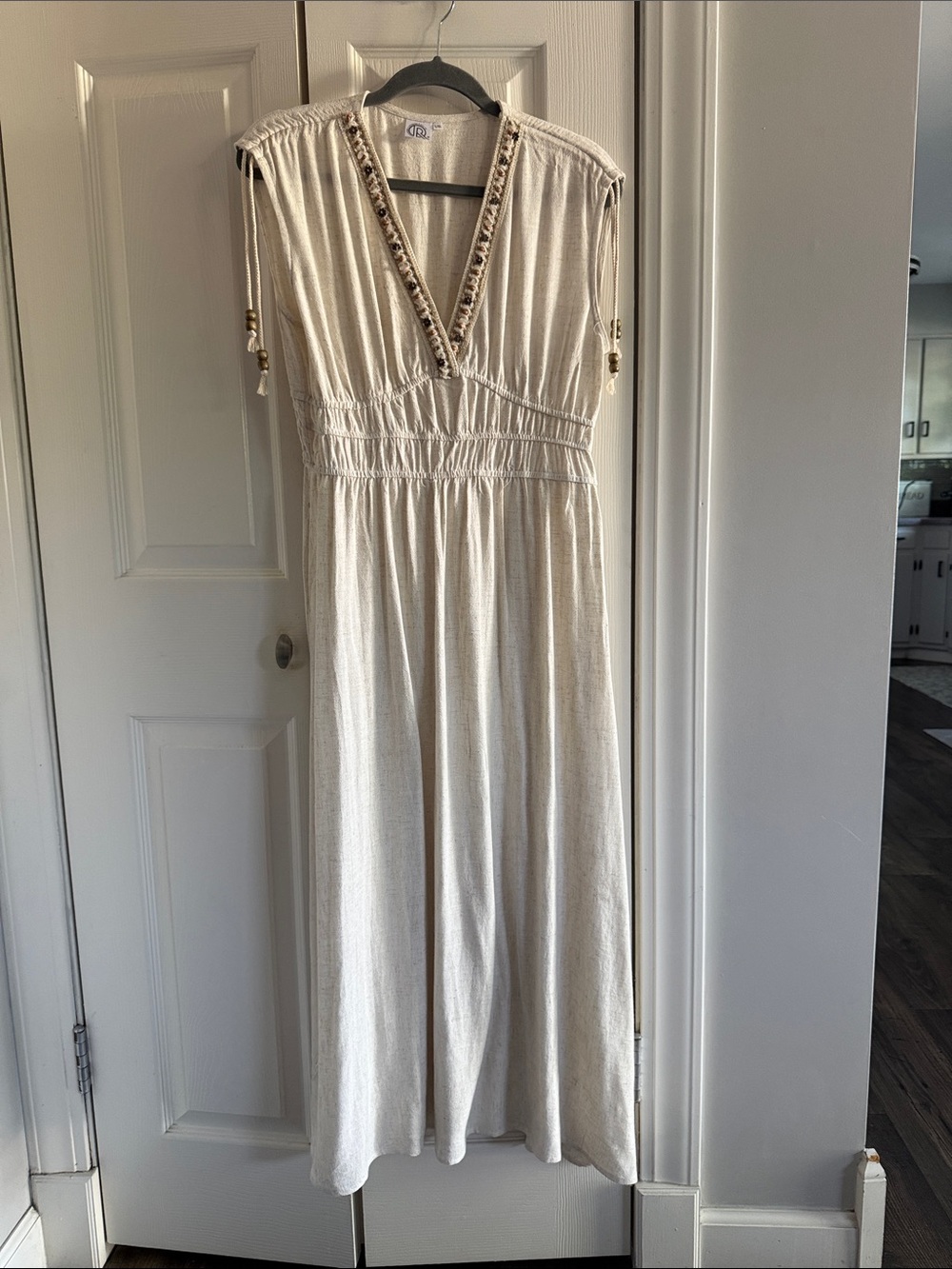 Soft Cream Maxi Dress with Beaded V-Neck and Tassel Details